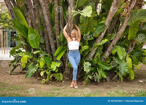 Mature Woman Beautiful Blonde With White Top And Jeans In A Smiling