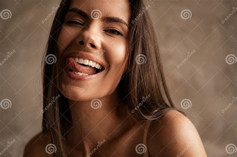 Portrait Of Aesthetic Beautiful Young Lady Blinking Eye Lick Teeth