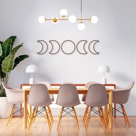 A Dining Room Table With Four Chairs In Front Of It And The Moon Phases