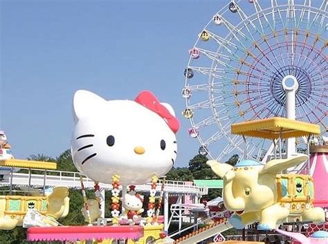 an amusement park with hello kitty rides and ferris wheel