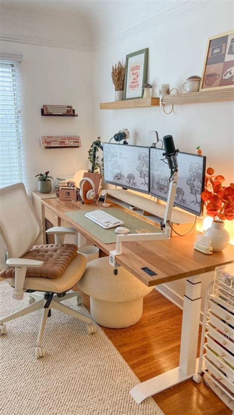 A Home Office With Two Computer Screens On The Wall And A Chair In