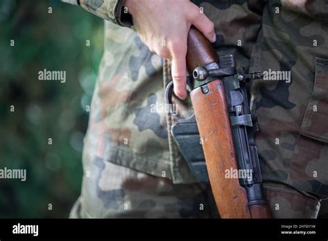A Lady Soldier Inspects A Newly Received Self Reloading Rifle A Close