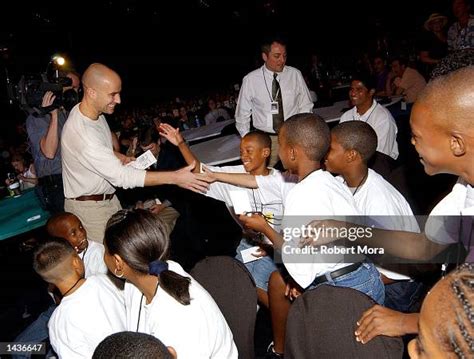 Tennis player Andre Agassi greets children during Kids' Day at... News ...