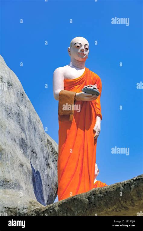 Statue Of A Buddhist Monk In The Ancient Temple Of Dambulla Sri Lanka