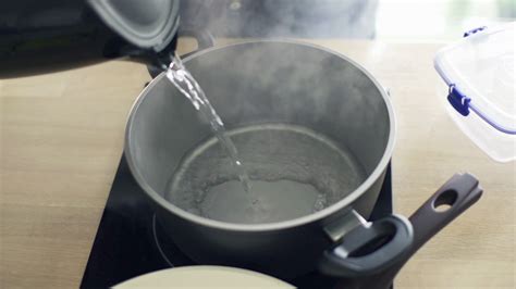 Pouring Boiling Water From Kettle Into Pot Stock Footage Sbv