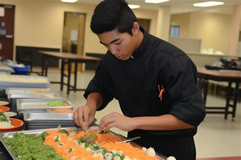 A Man In A Chefs Uniform Preparing Food On A Table Premium AI