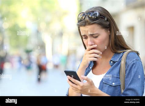 Sad Girl Complaining Checking Smart Phone Content Standing In The