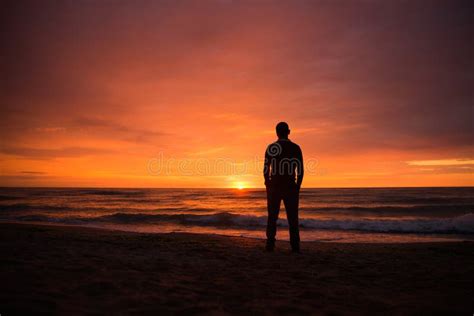 Single Man Watching A Dramatic Sunset By The Sea Stock Image Image Of