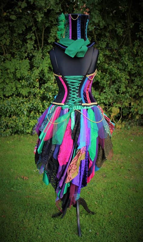 A Dress Made Out Of Multicolored Fabric On A Mannequin In The Grass