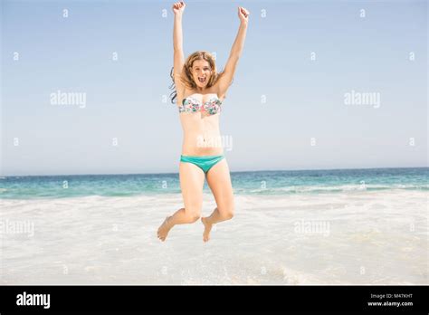 Carefree Woman In Bikini Jumping On The Beach Stock Photo Alamy