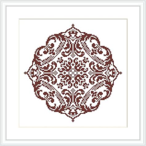 A Cross Stitch Pattern With An Ornate Design In Brown And White On A