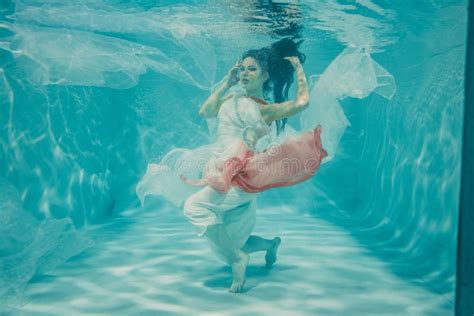 Hot Slim Brunette Woman Posing Swimming Under Water In Beautiful