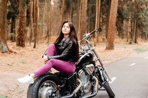 Premium Photo The Beautiful Brunette Riding A Motorcycle In The Park