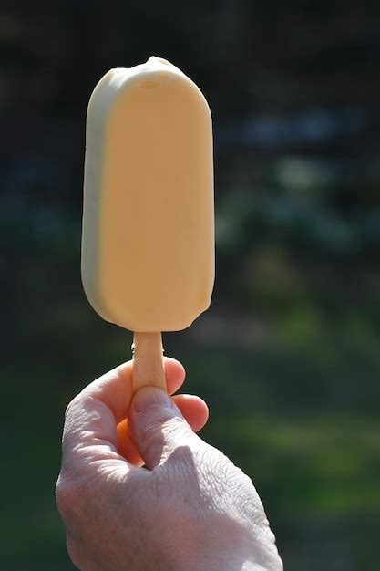 Premium Photo Midsection Of Person Holding Ice Cream Cone