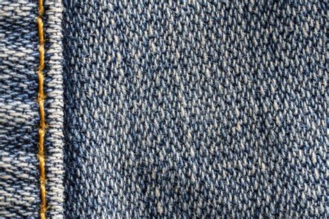 Blue Jeans Fabric Background Or Denim Texture With Seam Closeup View