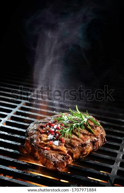 Beef Steak On Grill Smoke Flames Stock Photo Edit Now 1707971884