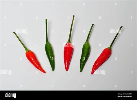 Multi Colored Chili Peppers Against White Background Stock Photo Alamy