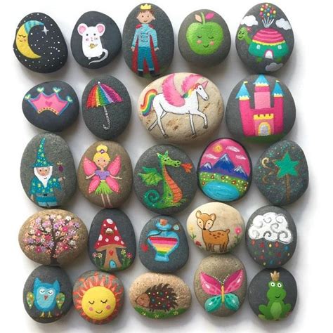 A Collection Of Painted Rocks Sitting On Top Of Each Other