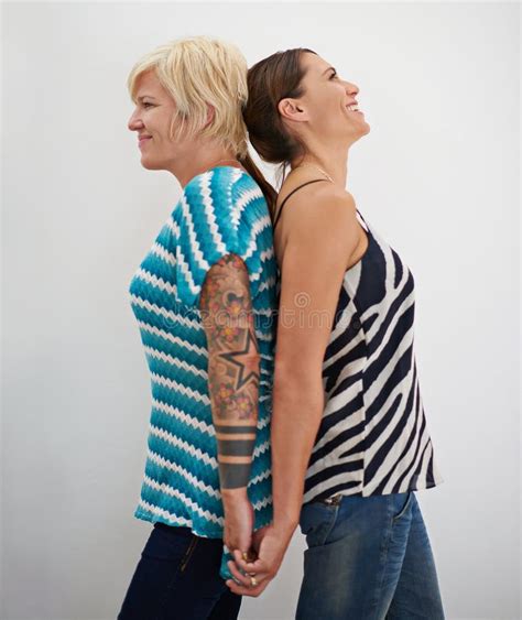 Back To Back And Hand In Hand A Lesbian Couple Standing Back To Back Holding Hands Stock Photo