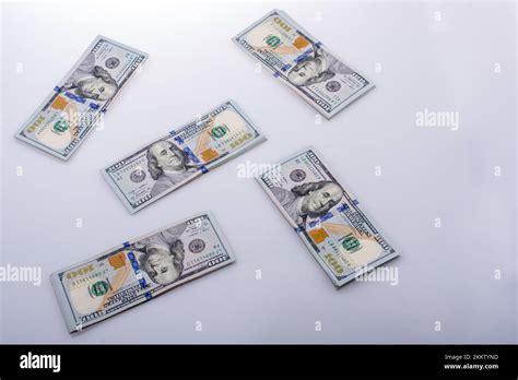 American 100 Dollar Banknote Bundles Placed On White Background Stock