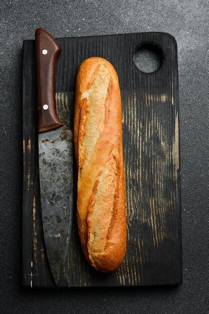 Premium Photo Fresh Crispy Baguette On A Black Slate Table Top View