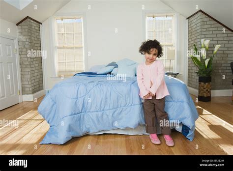 Girl Leaning Against The Bed Stock Photo Alamy
