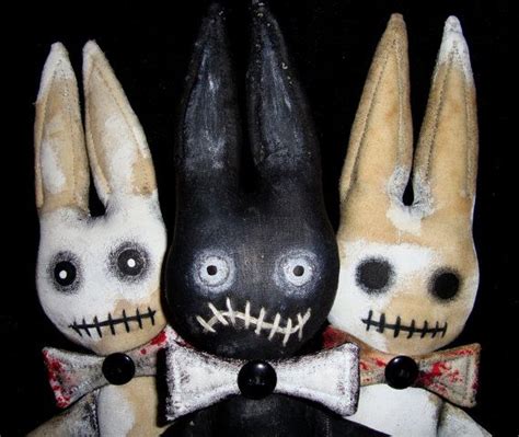 Three Stuffed Rabbits Wearing Black And White Clothes With Creepy Faces