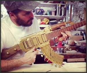 A Man Working On A Guitar In His Shop