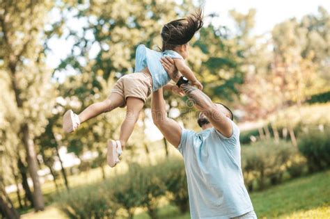 Dad And Daughter Having Fun In The Park And Looking Enjoyed Stock Image