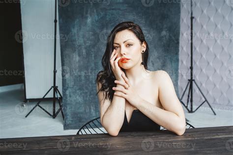 Brunette Woman Sitting At Table On Dark Gray Copy Space Background Stock Photo At Vecteezy