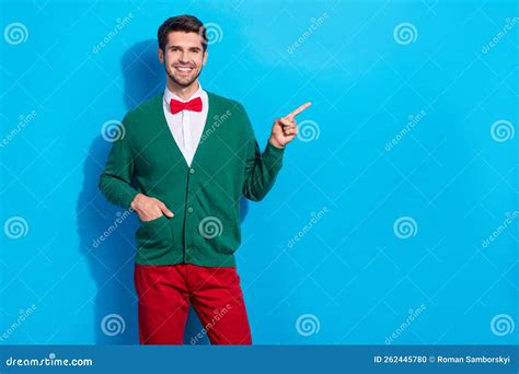 Photo Of Funny Cheerful Guy Dressed Xmas Green Cardigan Pointing Finger Empty Space Isolated