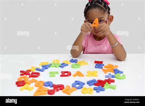 4 Year Old Latina Brunette Girl Plays With Colored Letters And Forms