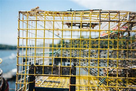 Lobster Trap Stacked On A Dock In A Maine Harbor By Stocksy