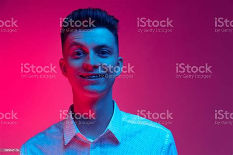 Young Happy Man In White Shirt Smiling Isolated Over Magenta Color