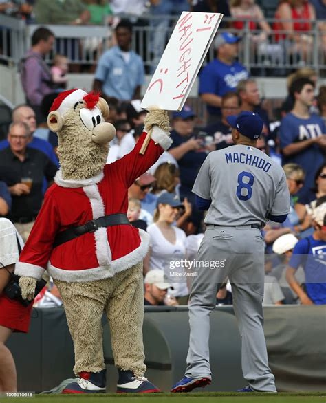 Atlanta Braves mascot Blooper, wearing a Santa Claus costume, holds ...