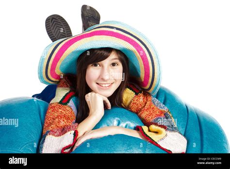 Beautiful Girl Lying On A Bean Bag In A Hat Isolated Over White