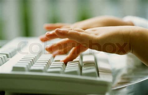 Child typing close up a picture of keyboard | Stock Photo | Colourbox