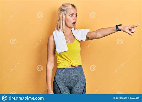 Beautiful Blonde Sports Woman Wearing Workout Outfit Pointing With