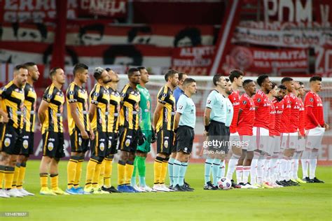 Players pf Deportivo Tachira and Internacional line up before a match ...