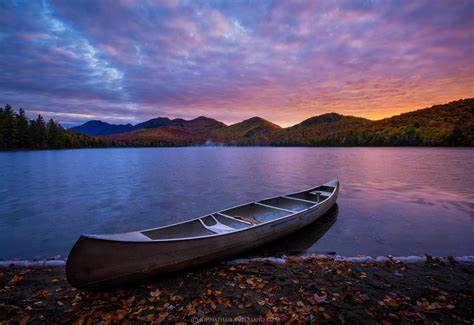 Clear Pond And Aluminum Canoe Parked At Sunrise Elk Lake Preser New