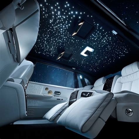 the interior of a limo with white leather seats and stars in the sky on ...