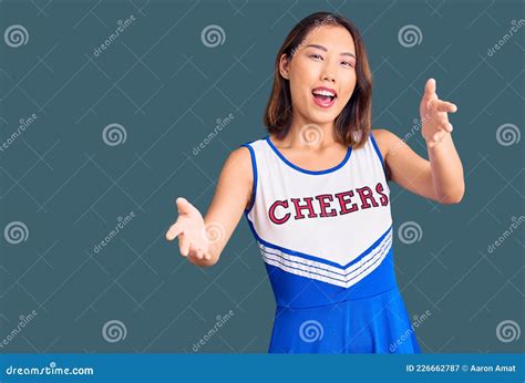 Young Beautiful Chinese Girl Wearing Cheerleader Uniform Smiling