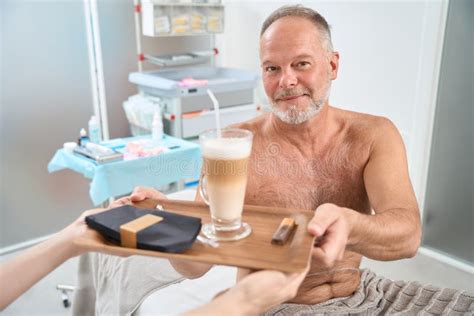 Man Sits On A Couch With Naked Torso In Ward Stock Image Image Of