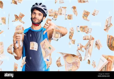 Handsome Hispanic Man Wearing Bike Helmet And Holding Water Bottle With