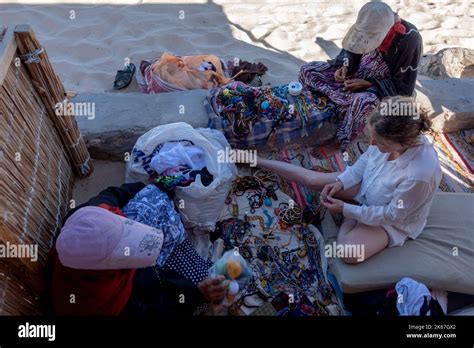 Bedouin Women Selling Handicraft Souvenirs To A Tourist In Ras El Satan