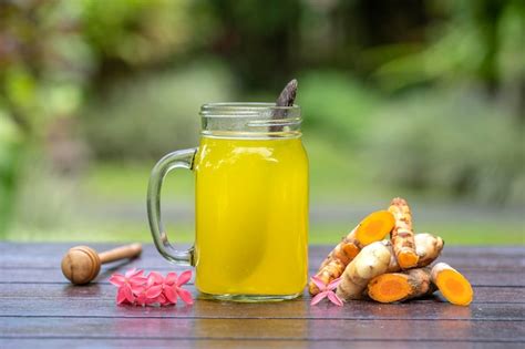 Premium Photo Energy Tonic Drink With Turmeric Ginger Lemon And Honey In Glass Mug Nature