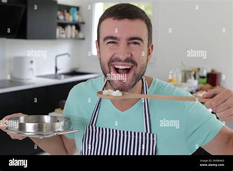 Man Tasting Some Food His Is Preparing In The Kitchen Stock Photo Alamy