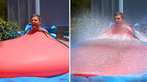 VIDEO: Watch as this giant water balloon pops in slow motion with man ...