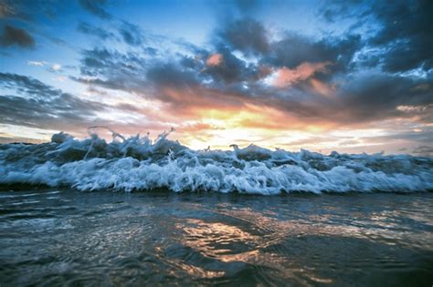 Premium Photo The Foamy Sea Lapping Against The Sandy Beach Against