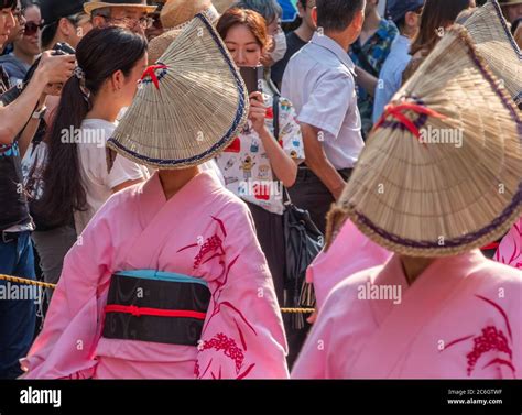 Folk Dancers In Colorful Yukata And Amigasa Straw Hat Dancing In